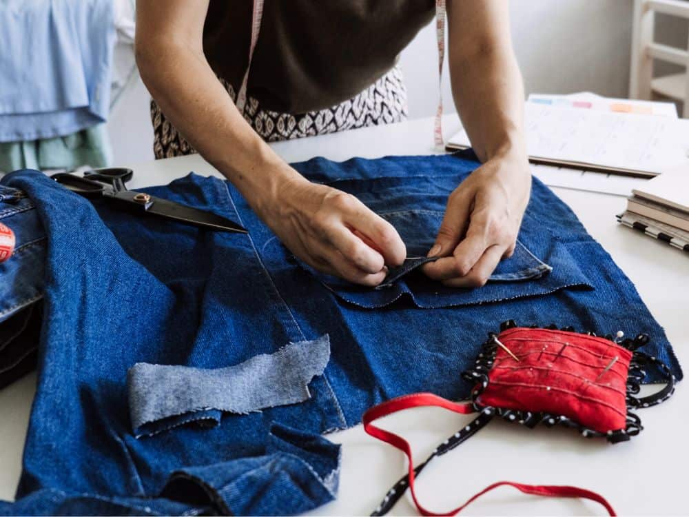 What To Do With Old Jeans: 7 Denim Recycling Ideas To Make Old Blue Jeans Green Image by irynakhabliuk via Canva Pro #whattodowitholdjeans #upcyclewhattodowitholdjeans #whattodowitholddenimjeans #denimrecycling #denimrecyclingprograms #denimrecyclingprojects #sustainablejungle