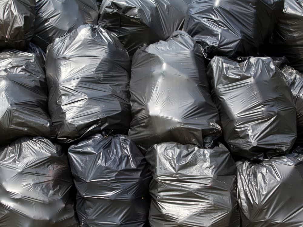 Let’s Talk Trash: Are Trash Bags Recyclable? Image by wellphoto via Getty Images on Canva Pro #aretrashbagsrecyclable #aregarbagebagsrecyclable #canyourecycleplastictrashbags #areplasticgarbagebagsrecyclable #sustainablejungle