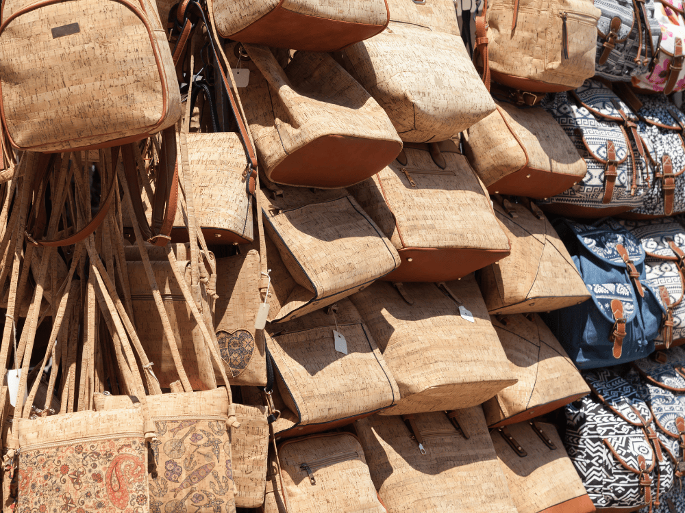 Bags made from cork fabric, a natural and sustainable material used in eco friendly fashion.