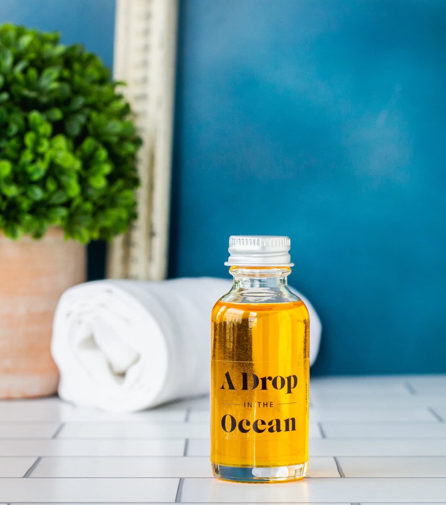 A Drop in the Ocean Revitalizing Skin Serum in a refillable glass bottle with aluminum cap, one of the best plastic-free skincare products