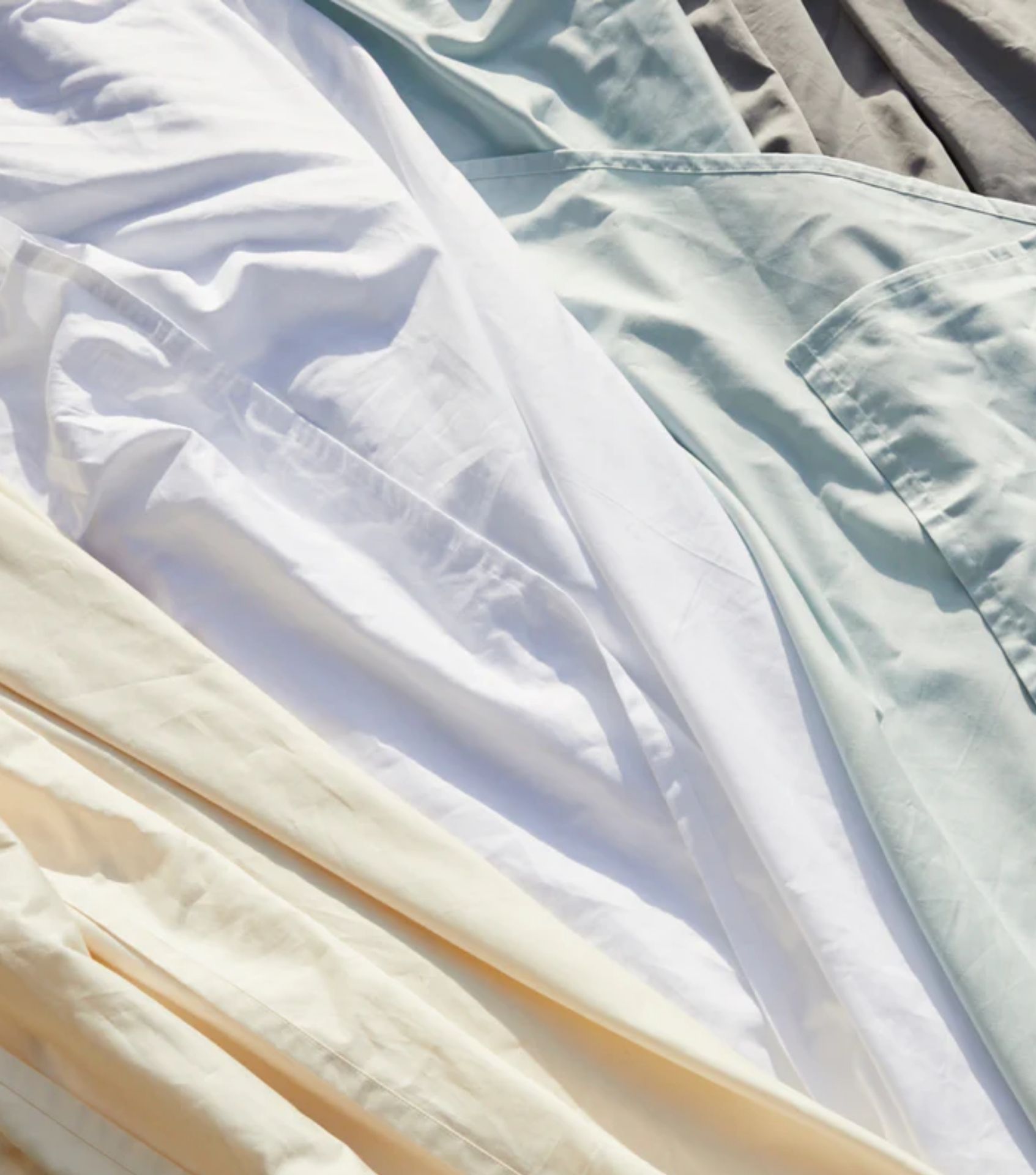 Avocado Green Mattress make Sustainable Bedding from linen and organic cotton. Thei range of minimalist colors are pictured here