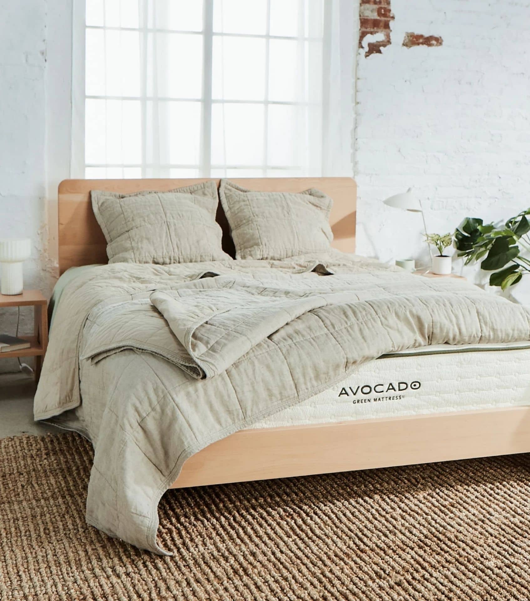 Avocado Green Mattress make Sustainable Bedding from linen and organic cotton. A green linen quilt set is pictured here.