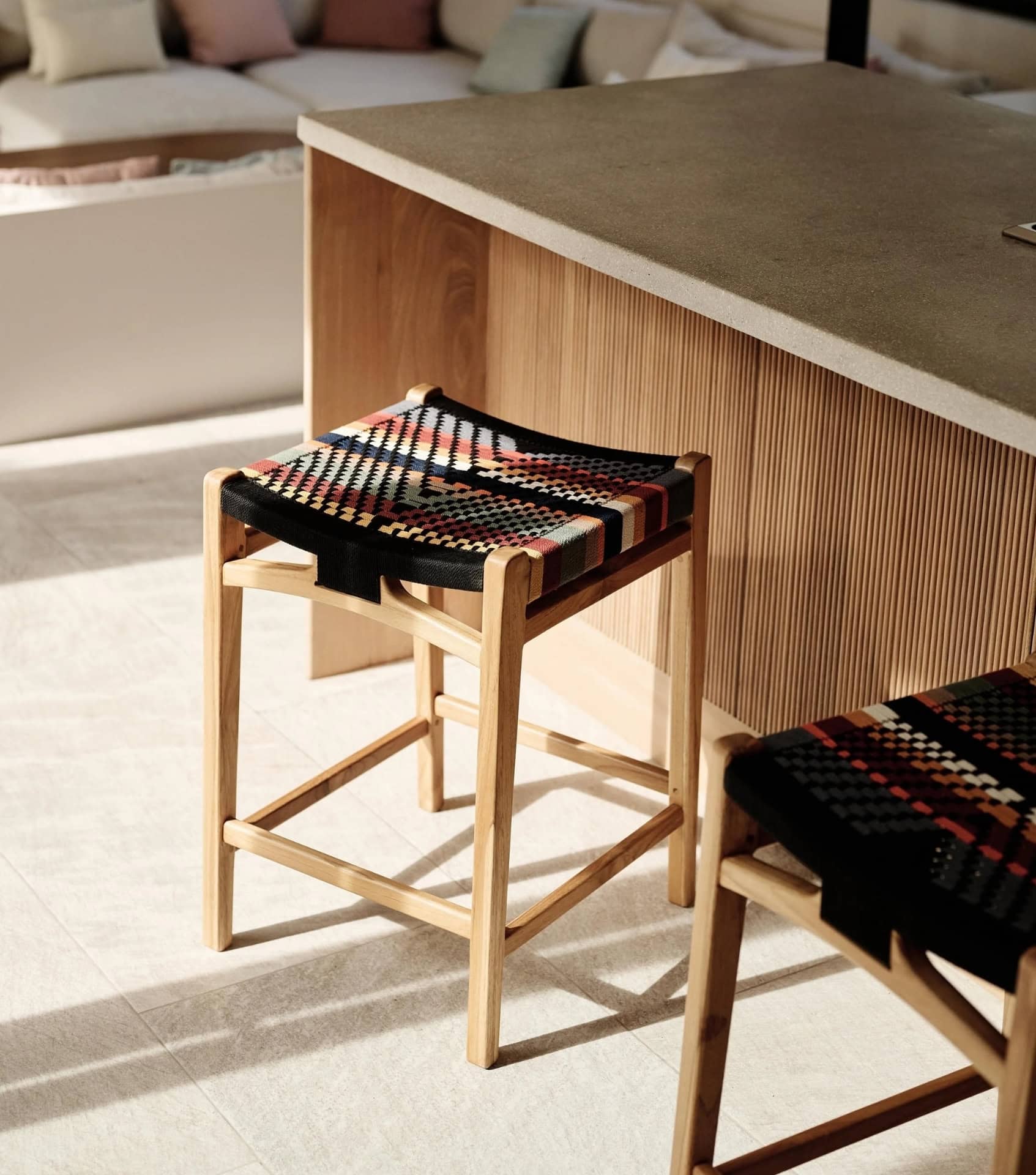 Sustainable home decor with handwoven wooden stool featuring colorful textile seat