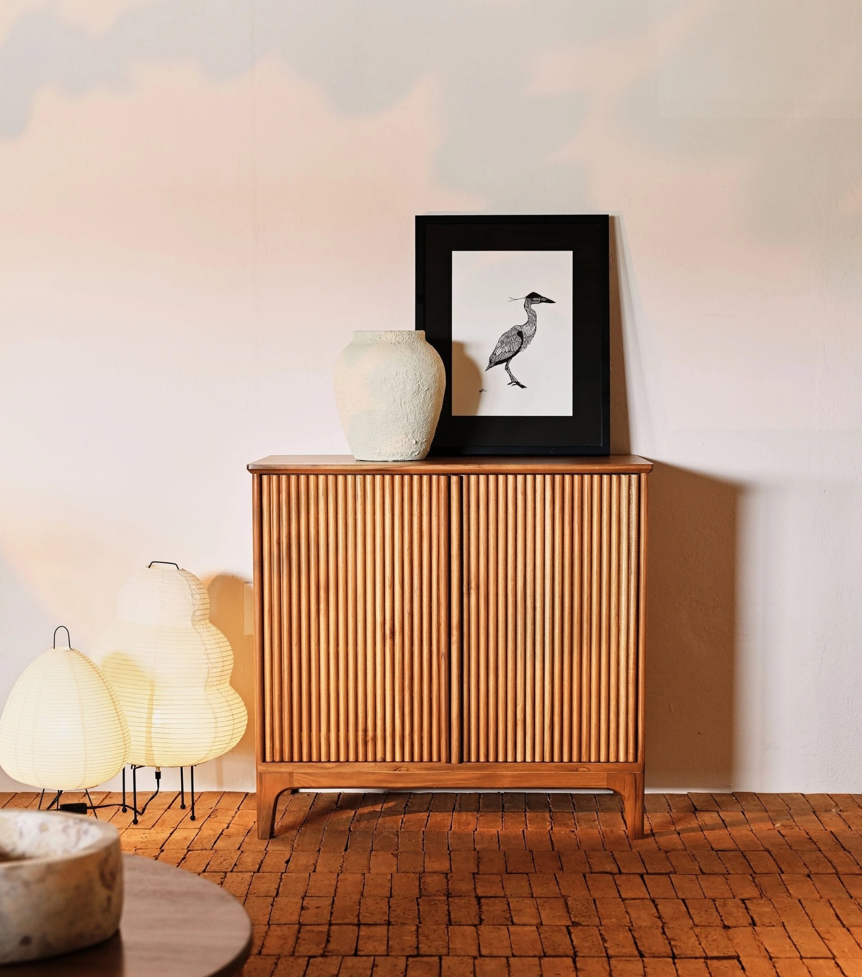 Sustainable home goods including mid-century modern wooden cabinet with textured front panel