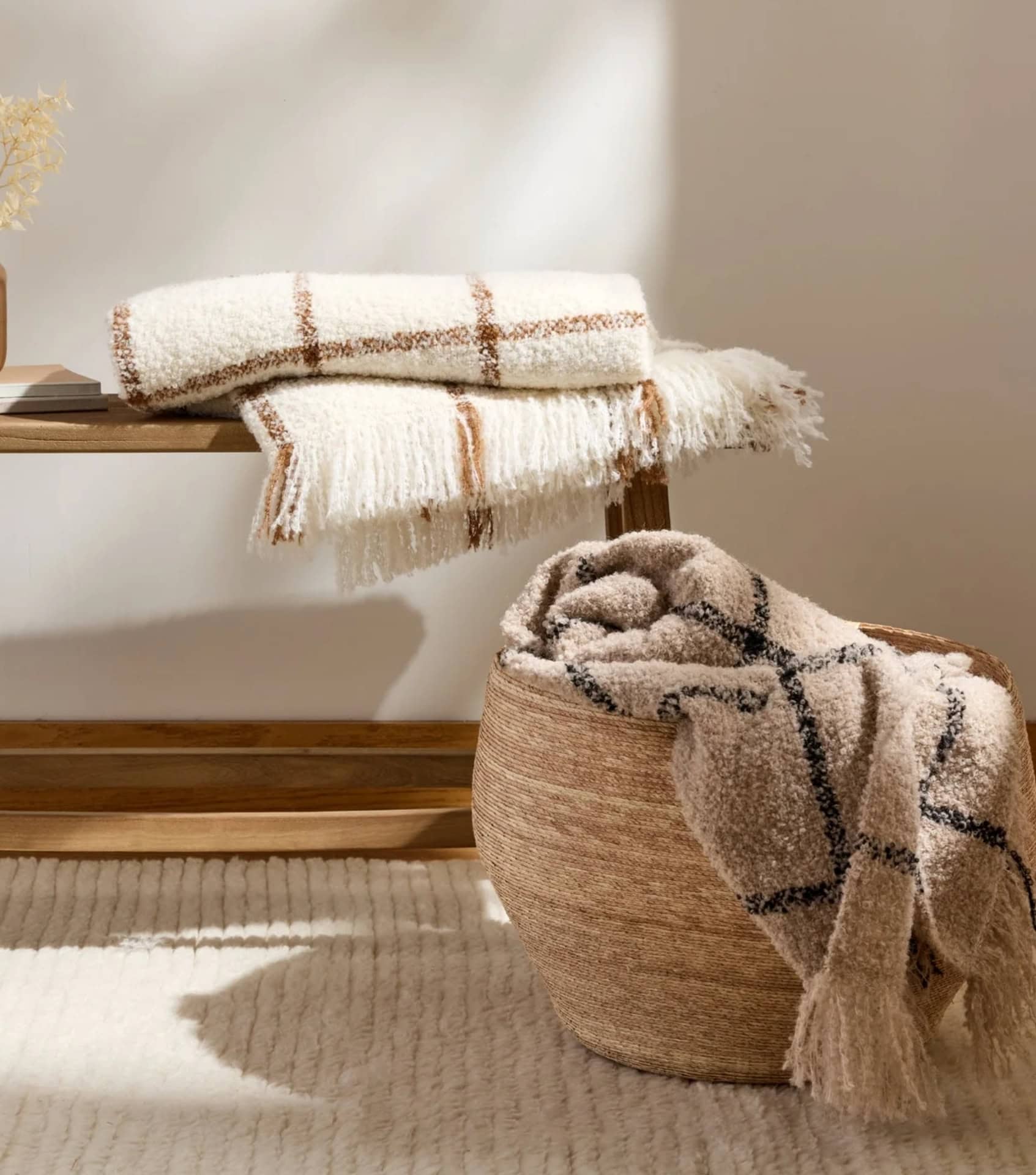 Sustainable home decor with textured throws in woven basket and neutral bathroom textiles