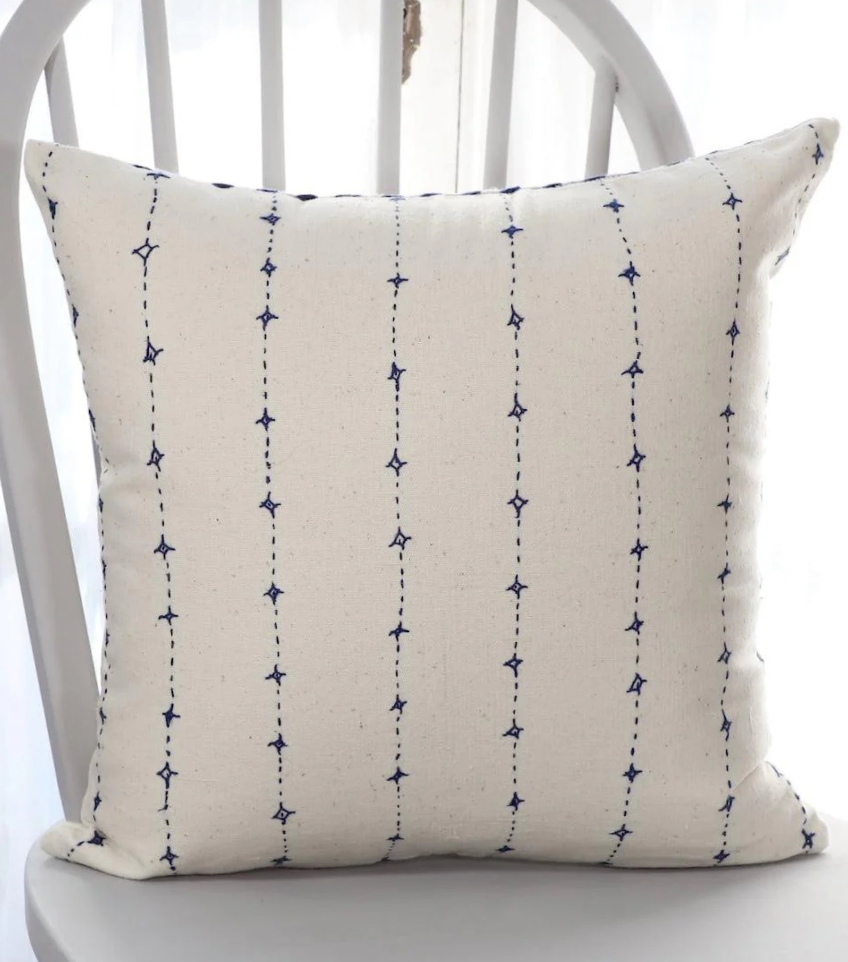 Sustainable home decor with hand-stitched natural cotton pillow in minimalist design
