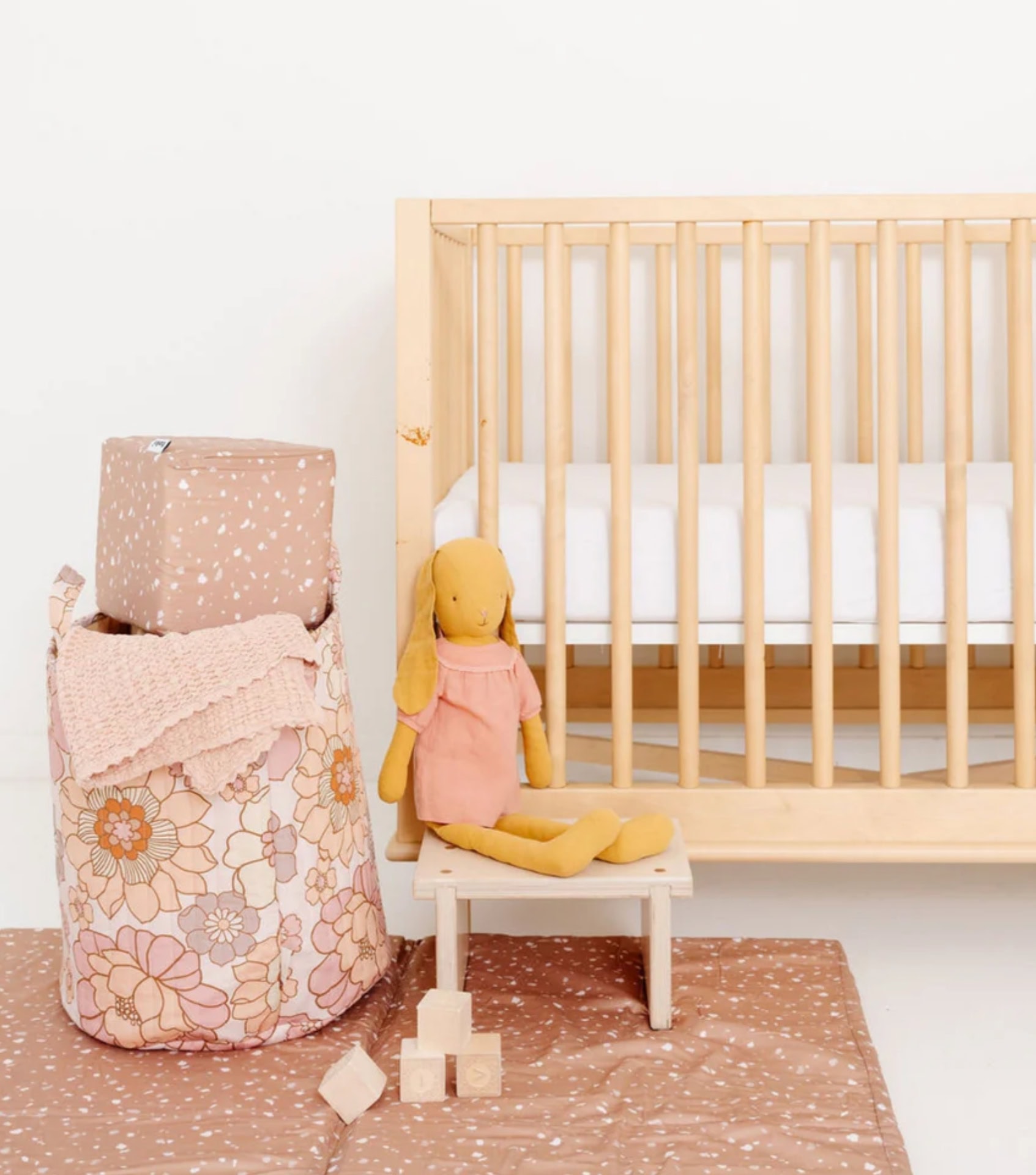 Sustainable home decor in nursery setting with natural wood crib and organic cotton textiles