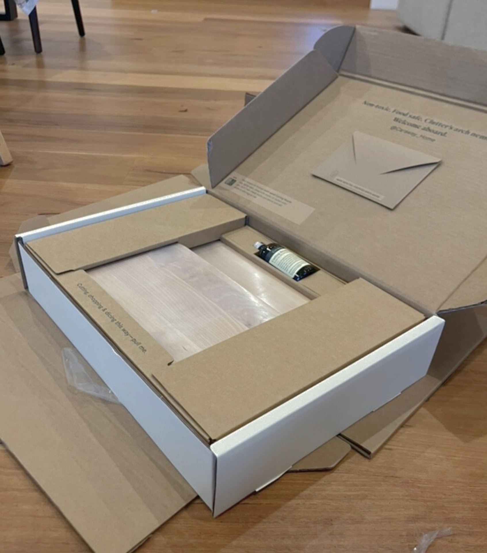 Caraway cutting board set unboxing showing three birch wood boards and storage organizer in plastic-free packaging