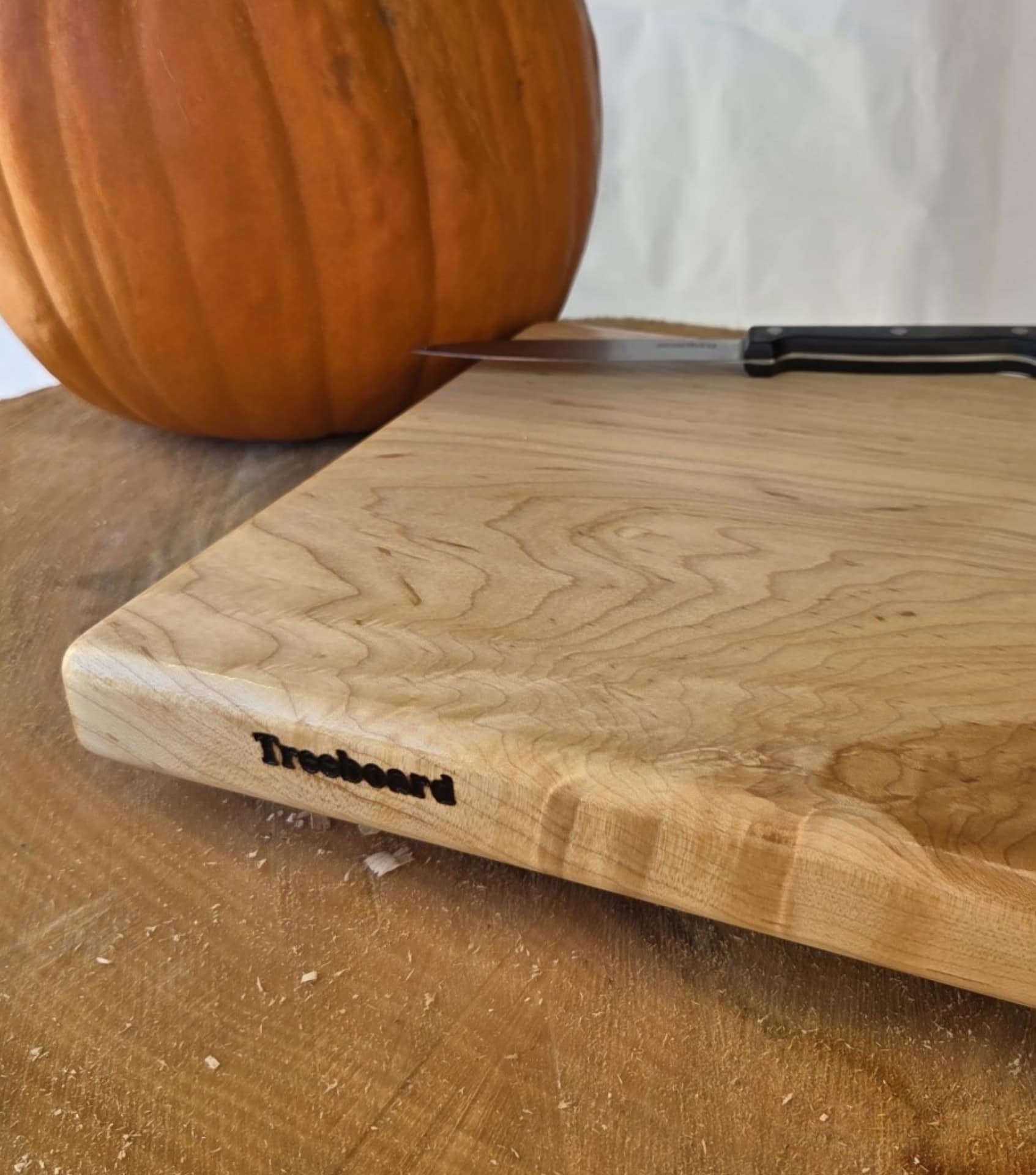 Close-up of Treeboard maple cutting board showing natural wood grain and solid single-piece construction without glue